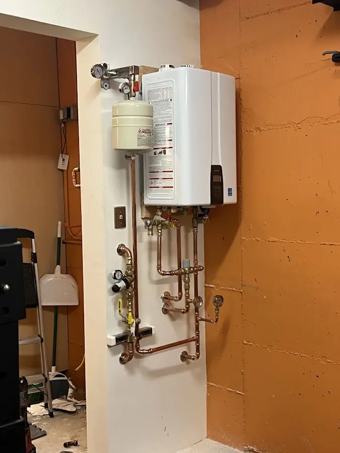 Plumbing technician inspecting water heater connections in Laguna Beach